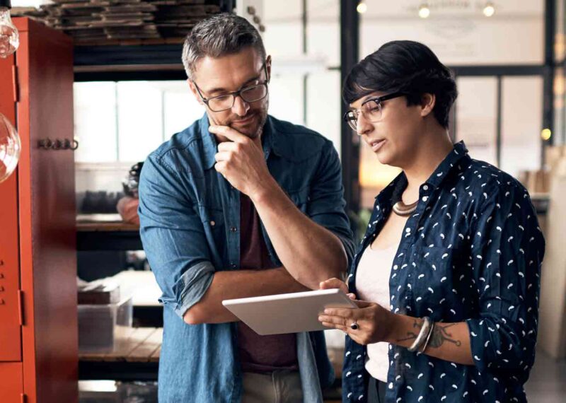 Man and Woman reviewing PDS specs on a tablet